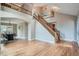 Open foyer with a staircase leading to the second floor, hardwood floors and a dining area at 5784 W 81St Cir, Arvada, CO 80003