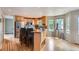 Bright, open kitchen with an island, stainless steel appliances, and hardwood floors at 5784 W 81St Cir, Arvada, CO 80003
