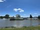 Scenic lake view with fountain, bridge, gazebo and lush green landscape under a blue sky at 5784 W 81St Cir, Arvada, CO 80003