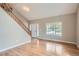 Bright living room with hardwood floors, a staircase and a large window offering plenty of natural light at 5784 W 81St Cir, Arvada, CO 80003