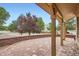 Charming covered patio with brick flooring and sturdy wooden support beams at 5784 W 81St Cir, Arvada, CO 80003