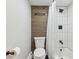 Modern bath features tiled shower and dark plank accent wall at 33 N Corona St # 401, Denver, CO 80218