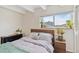 Bedroom with a large window, plants, beamed ceiling, and a queen sized bed at 33 N Corona St # 401, Denver, CO 80218