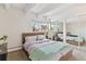 Bedroom featuring neutral decor, a picture window with plants, and mirrored closet doors at 33 N Corona St # 401, Denver, CO 80218
