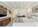 Spacious bedroom features beamed ceilings, neutral walls and carpet, and vintage furniture at 33 N Corona St # 401, Denver, CO 80218