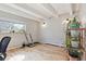 Bright room with wooden floors, open ceiling beams, and large window provides workout area at 33 N Corona St # 401, Denver, CO 80218