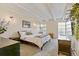 Primary bedroom with white ceiling beams, neutral decor, and a modern, unique style at 33 N Corona St # 401, Denver, CO 80218