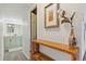 Hallway featuring an ornate wooden shelf with decorative items, opening to a bathroom at 33 N Corona St # 401, Denver, CO 80218