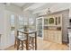 Bright kitchen features a breakfast nook with light wood floors, white ceiling beams, and a built-in hutch at 33 N Corona St # 401, Denver, CO 80218