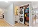 Convenient laundry area with stacked washer/dryer and storage solutions in a hall bath at 33 N Corona St # 401, Denver, CO 80218