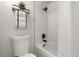 Modern bathroom featuring a white tiled shower over tub and sleek matte black fixtures at 7770 W 38Th Ave # 108, Wheat Ridge, CO 80033