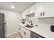 The modern kitchen features white cabinetry, sleek appliances, and stylish fixtures, creating a functional and stylish space at 7770 W 38Th Ave # 108, Wheat Ridge, CO 80033