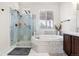 Bathroom with soaking tub, walk-in shower, and marble tile at 806 Ridgemont Cir, Highlands Ranch, CO 80126