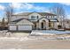 Two-story home with three-car garage and landscaped front yard at 806 Ridgemont Cir, Highlands Ranch, CO 80126