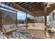 Pergola-covered patio with fire pit, comfortable seating, and backyard views at 806 Ridgemont Cir, Highlands Ranch, CO 80126