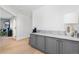 Convenient wet bar with gray cabinets and a marble countertop at 806 Ridgemont Cir, Highlands Ranch, CO 80126