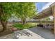 Expansive backyard with a covered patio area and mature trees at 7828 Florado St, Denver, CO 80221