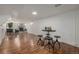 Open basement area with brick fireplace and bar seating area at 7828 Florado St, Denver, CO 80221