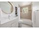 Bright bathroom with updated vanity, stylish mirror, tub, and tile shower at 7828 Florado St, Denver, CO 80221