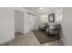 Well-lit bedroom featuring a sliding barn door to a walk-in closet and room for comfortable seating at 7828 Florado St, Denver, CO 80221