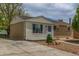 Exterior side and front view featuring a combination of siding and brick, complemented by a concrete driveway at 7828 Florado St, Denver, CO 80221