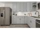 Beautiful kitchen with stylish grey cabinets, stainless steel refrigerator, and bright countertops at 7828 Florado St, Denver, CO 80221