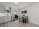 Well-lit kitchen with modern cabinetry, stainless steel appliances, and an eat-in dining table with stools at 7828 Florado St, Denver, CO 80221