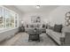 Bright living room with neutral decor, stylish furniture, and a large window for plenty of natural light at 7828 Florado St, Denver, CO 80221