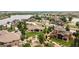 Stunning aerial view of luxury homes surrounding a serene lake with well-manicured lawns and mature trees at 5767 Pelican Shores Dr, Longmont, CO 80504