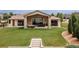 Spacious backyard featuring a covered patio, outdoor seating, and expansive green lawn at 5767 Pelican Shores Dr, Longmont, CO 80504
