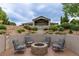 Landscaped backyard with a fire pit, stone retaining walls, and ample space for recreation at 5767 Pelican Shores Dr, Longmont, CO 80504