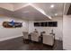 Basement seating area with three chairs, wall-mounted TVs, and unique fish wall decor at 5767 Pelican Shores Dr, Longmont, CO 80504
