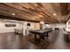 Expansive basement with wood ceiling, pool table, shuffleboard, seating, and entertainment area at 5767 Pelican Shores Dr, Longmont, CO 80504