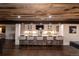 Basement bar features a custom white counter, exposed brick, and seating for six at 5767 Pelican Shores Dr, Longmont, CO 80504
