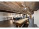 A finished basement with a rustic wood ceiling includes a game room and bar area at 5767 Pelican Shores Dr, Longmont, CO 80504