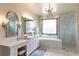Luxurious bathroom boasting marble finishes, a double vanity, and a separate shower and tub at 5767 Pelican Shores Dr, Longmont, CO 80504