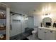 Modern bathroom featuring glass enclosed shower, white shiplap walls, and patterned tile floor at 5767 Pelican Shores Dr, Longmont, CO 80504