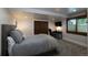 Comfortable bedroom with a large bed, closet with rustic wood doors, and home office area at 5767 Pelican Shores Dr, Longmont, CO 80504