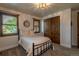 A cozy bedroom features wood windows with blinds, closet with wood sliding doors, and neutral decor at 5767 Pelican Shores Dr, Longmont, CO 80504