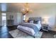 Bright bedroom features a unique antler chandelier, neutral decor, and a plush, comfortable bed at 5767 Pelican Shores Dr, Longmont, CO 80504