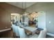 Dining area with a wooden table, upholstered chairs, and view to kitchen and living area at 5767 Pelican Shores Dr, Longmont, CO 80504