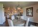 Dining area featuring a round wooden table, upholstered chairs, and a view into the kitchen at 5767 Pelican Shores Dr, Longmont, CO 80504