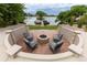 Charming fire pit area featuring a stone fire pit and comfortable seating overlooking the lake at 5767 Pelican Shores Dr, Longmont, CO 80504