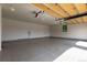 Spacious garage with epoxy flooring, ample lighting, and overhead door mechanism at 5767 Pelican Shores Dr, Longmont, CO 80504