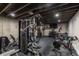 Well-equipped home gym with weight machines, stationary bike, and free weights at 5767 Pelican Shores Dr, Longmont, CO 80504