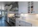 Close-up view of the kitchen featuring marble countertops, stainless steel appliances, and wine storage at 5767 Pelican Shores Dr, Longmont, CO 80504