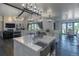 Open kitchen with marble countertops, stainless steel sink, kitchen island, and dining area at 5767 Pelican Shores Dr, Longmont, CO 80504