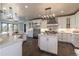 Spacious kitchen with an island, stainless steel appliances, hardwood flooring, and modern lighting fixtures at 5767 Pelican Shores Dr, Longmont, CO 80504