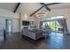 Living room showcasing a stone fireplace, vaulted ceilings, hardwood floors, and access to the patio at 5767 Pelican Shores Dr, Longmont, CO 80504