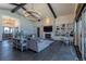 Open living area with a stone fireplace, built-in shelves, hardwood flooring, and modern lighting fixtures at 5767 Pelican Shores Dr, Longmont, CO 80504